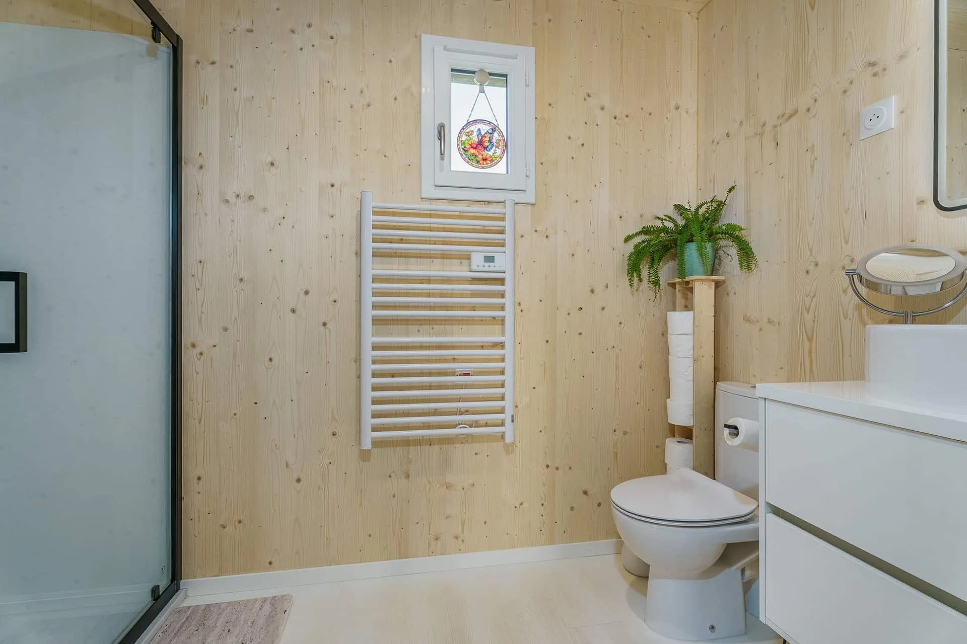 salle de bain maison 50m² · parois ossature bois, meuble vasque suspendu blanc, plantes vertes