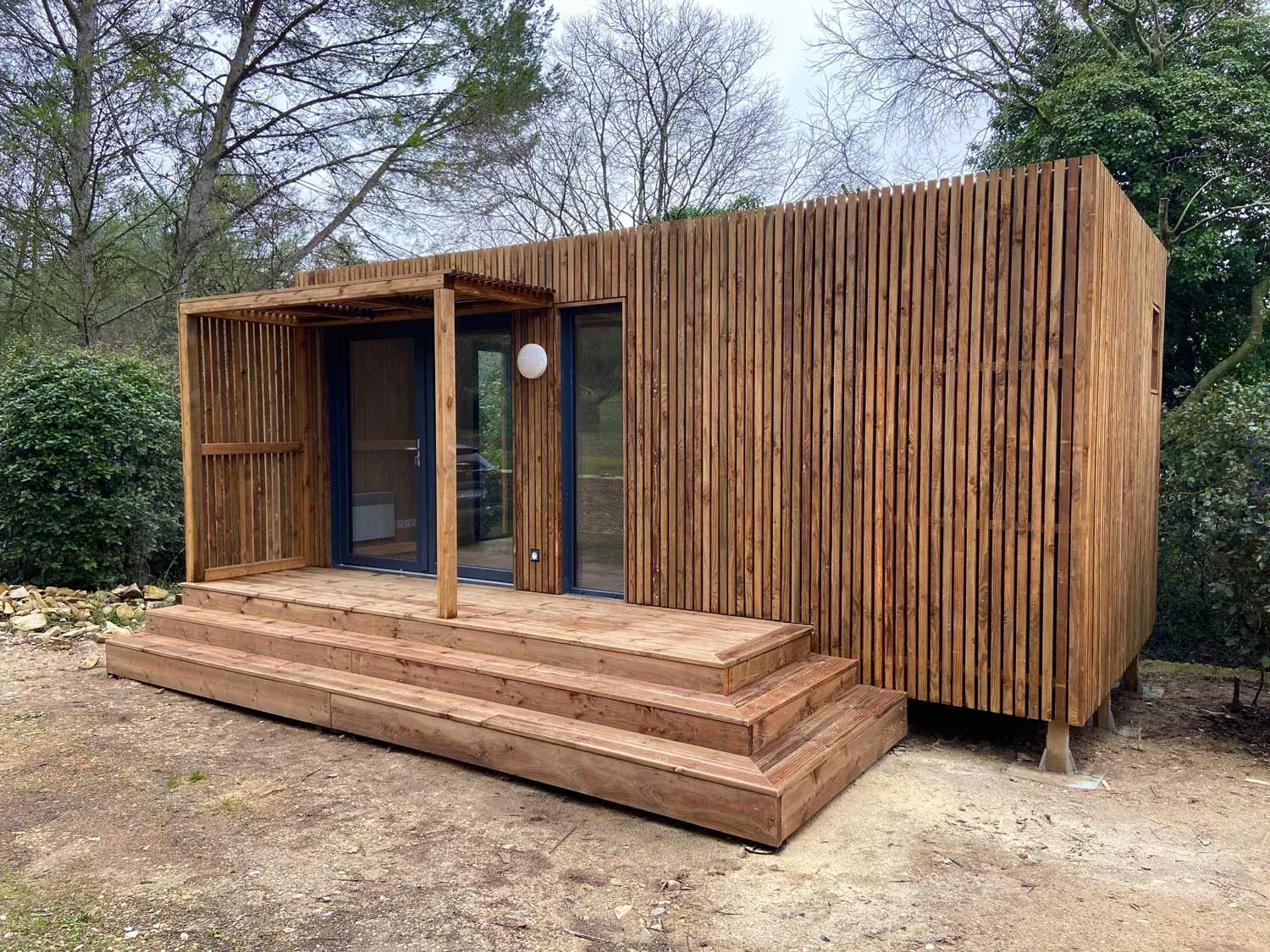 Un studio de jardin en bois servant de chambre d’amis